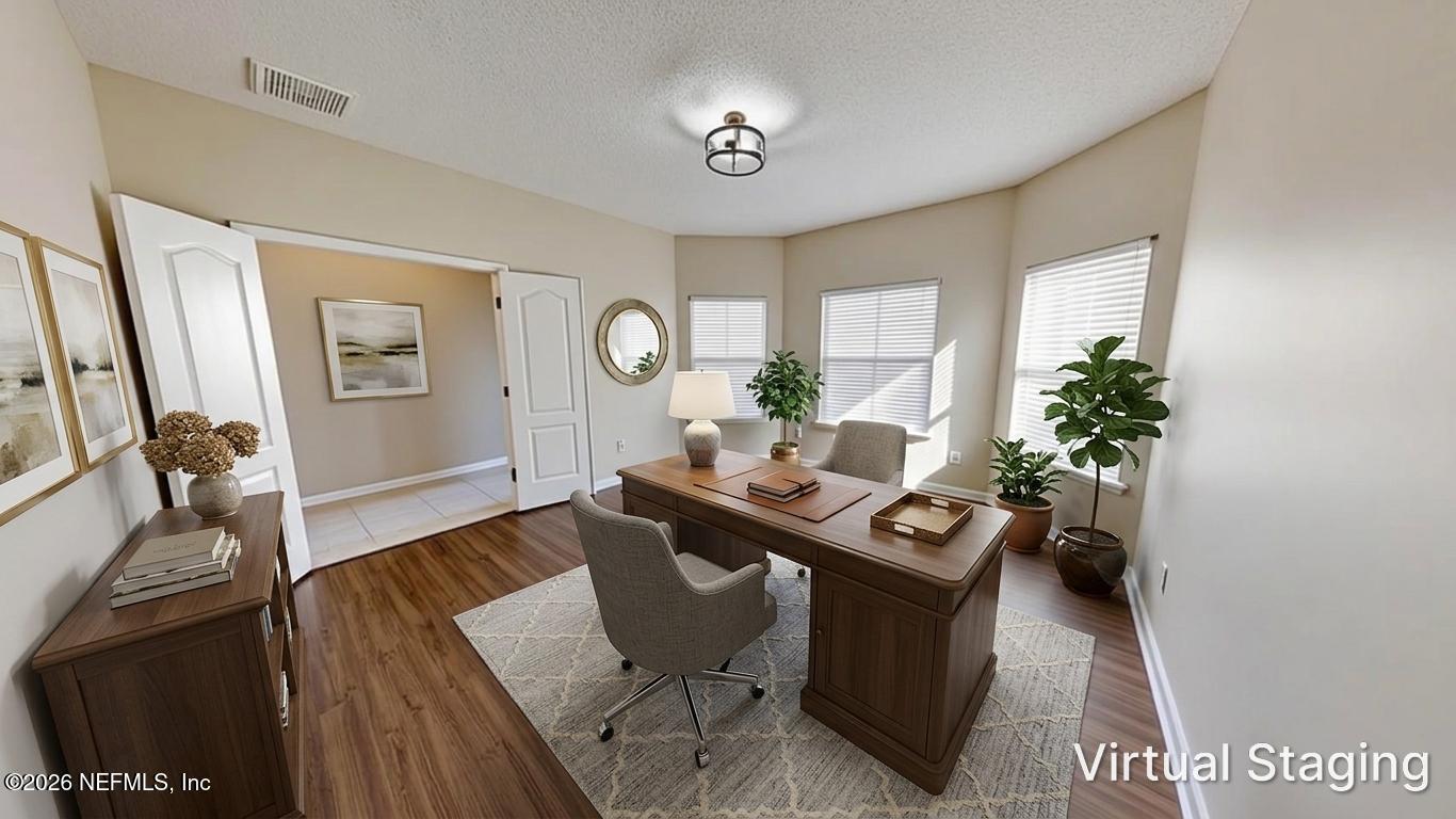 14454 Millhopper Road Jacksonville, FL 32258 - Photo 11 of 44 a view of a workspace with furniture and a potted plant