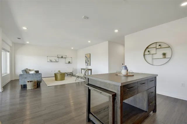 a kitchen with sink attached cabinets dining table and chairs