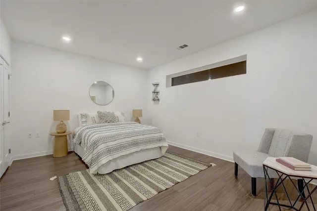 a living room with furniture a rug and kitchen view