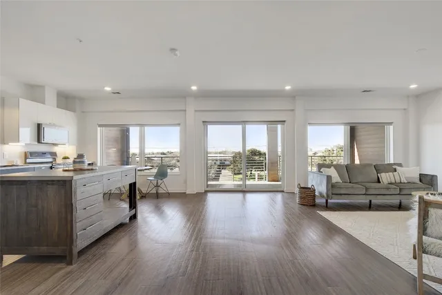 a large living room with stainless steel appliances granite countertop lots of counter top space and furniture