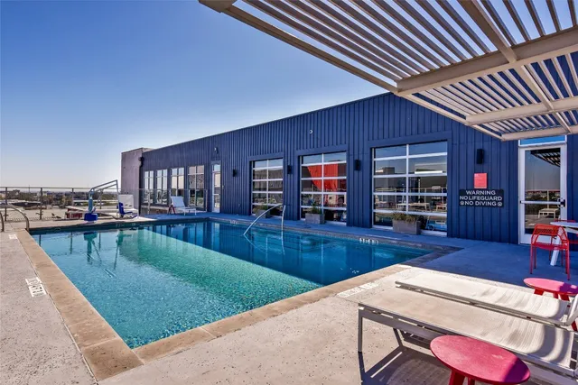a view of a swimming pool with outdoor seating