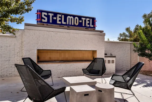 a living room with furniture and floor to ceiling window