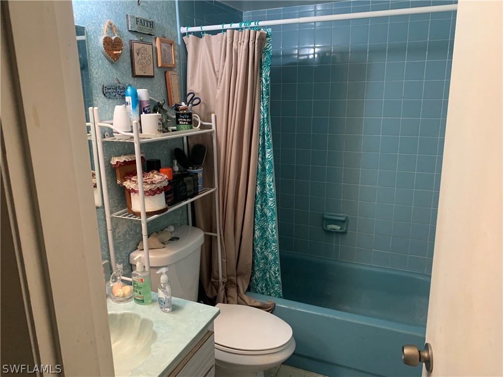 119 Rowland Road Lehigh Acres, FL 33936 - Photo 11 of 20 a bathroom with a toilet and a shower