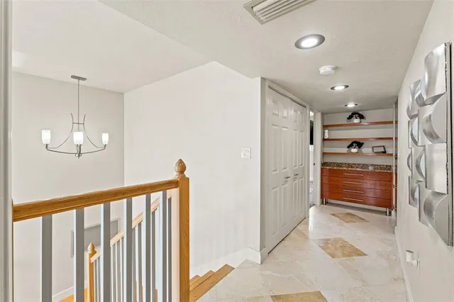 a spacious bedroom with a bed and a chandelier
