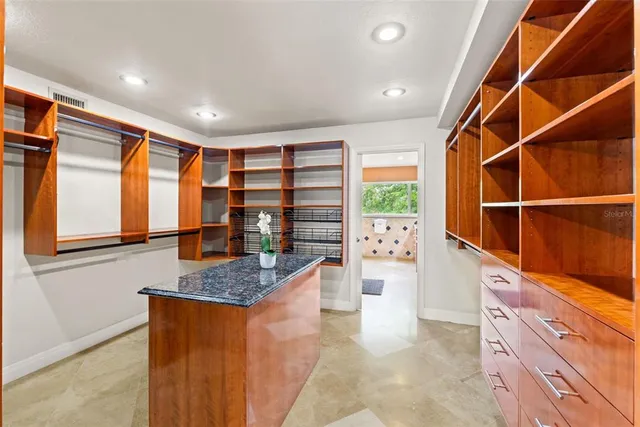 a large bathroom with a granite countertop tub a sink and a large mirror next to a window