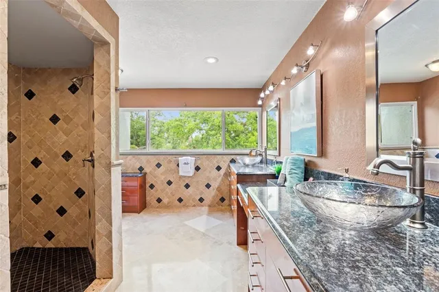a bathroom with a sink mirror and a bathtub