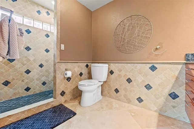 a bathroom with a granite countertop sink a mirror and vanity