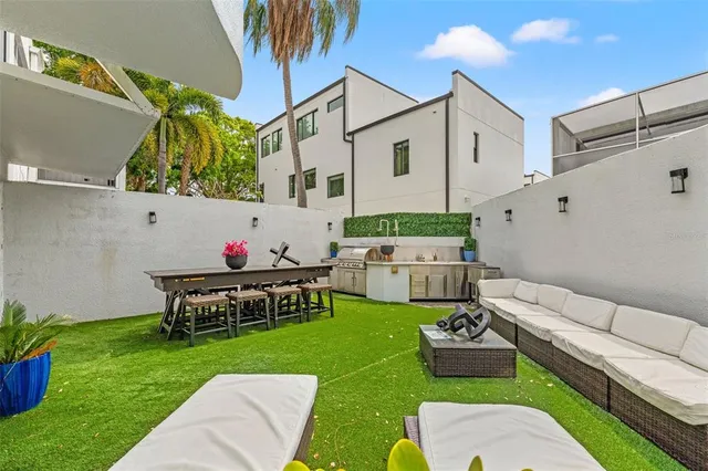 a view of a patio with table and chairs and potted plants
