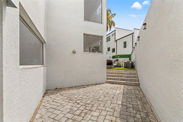 an aerial view of a house with garden space and deck
