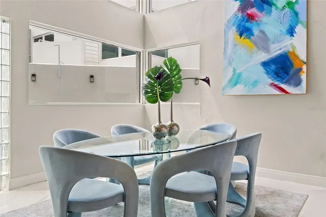 an open kitchen with stainless steel appliances kitchen island granite countertop a table and chairs in it