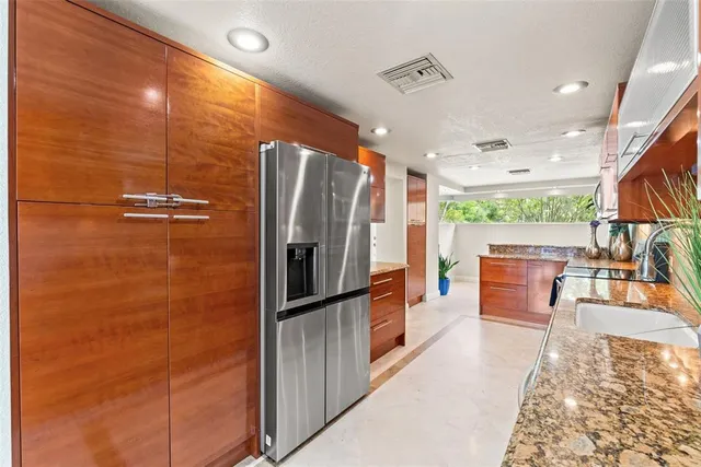 a kitchen with stainless steel appliances granite countertop a sink and a stove