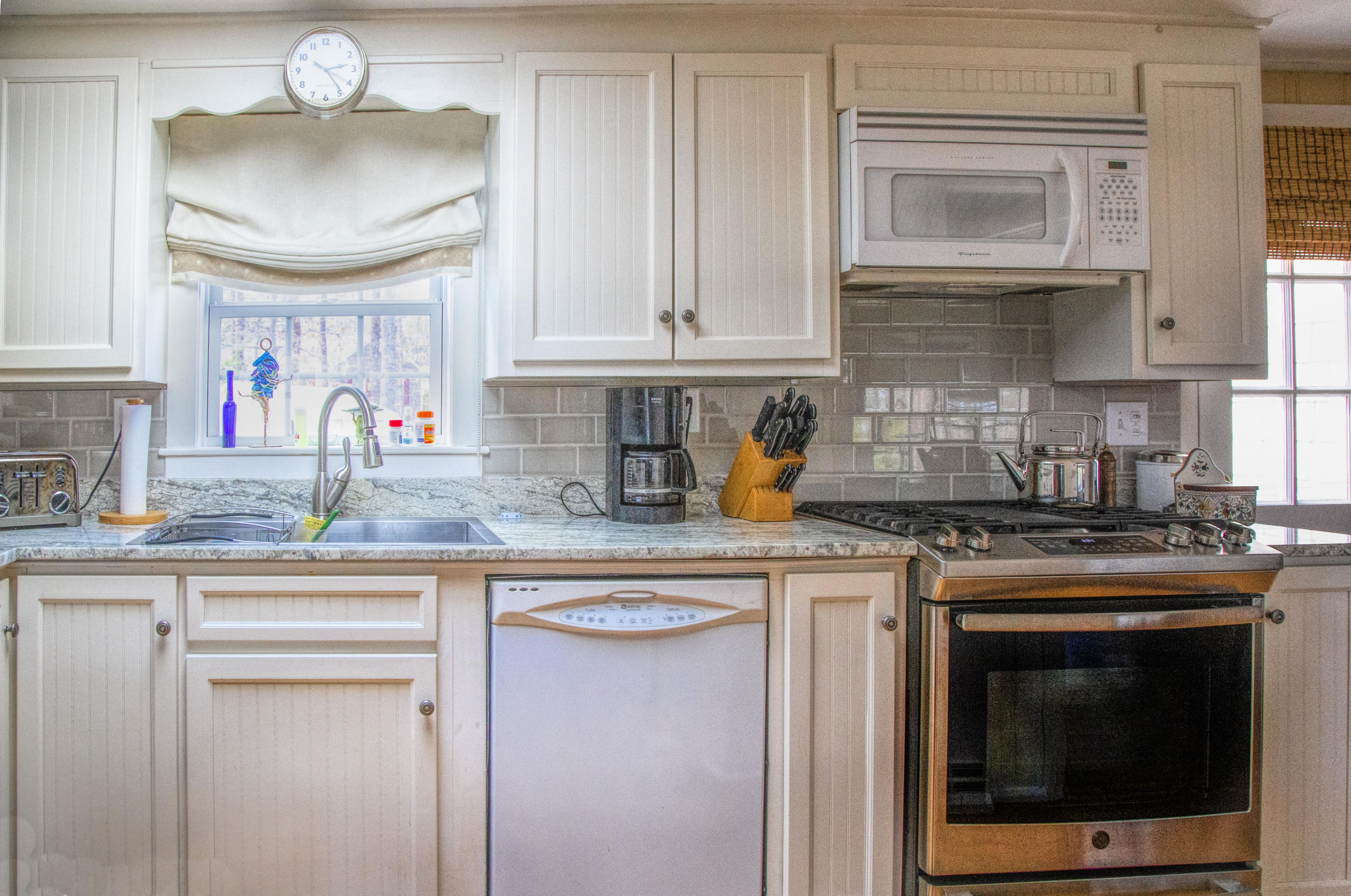 58 Aunt Debbys Road Dennis Port, MA 02639 - Photo 16 of 38 a kitchen with granite countertop a sink stainless steel appliances and cabinets