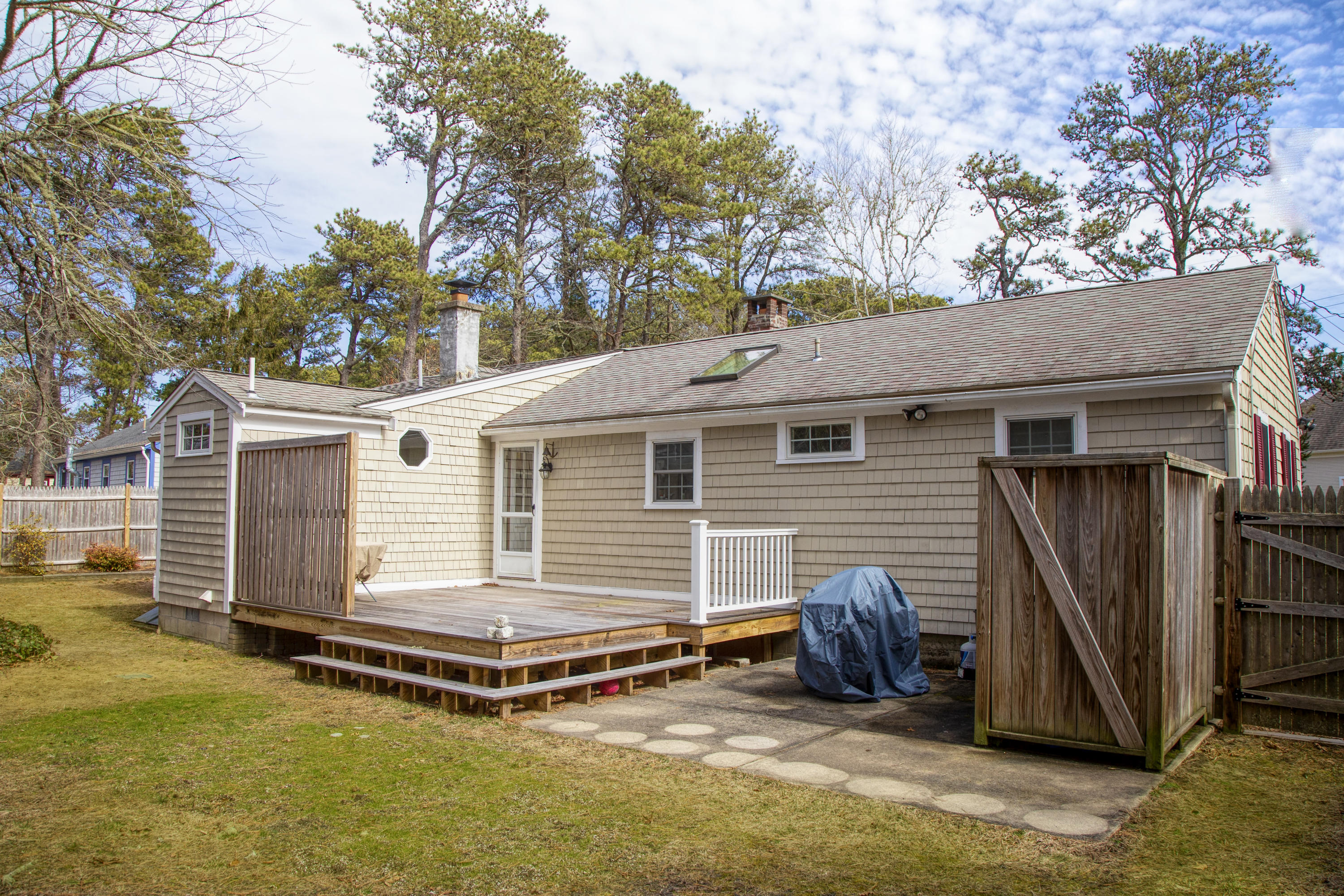 58 Aunt Debbys Road Dennis Port, MA 02639 - Photo 10 of 38 a view of a house with a patio and a yard