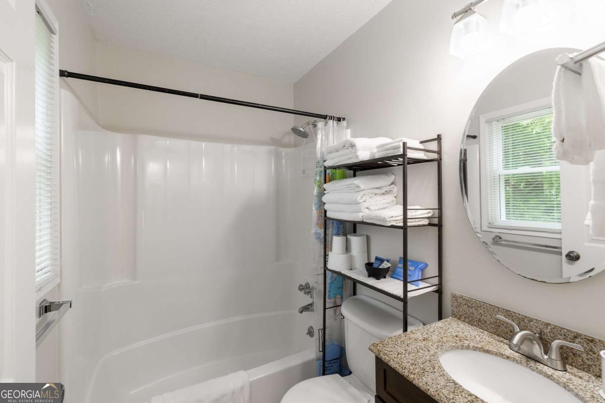 168 Pearl Street Athens, GA 30601 - Photo 24 of 43 a bathroom with a granite countertop sink toilet and shower