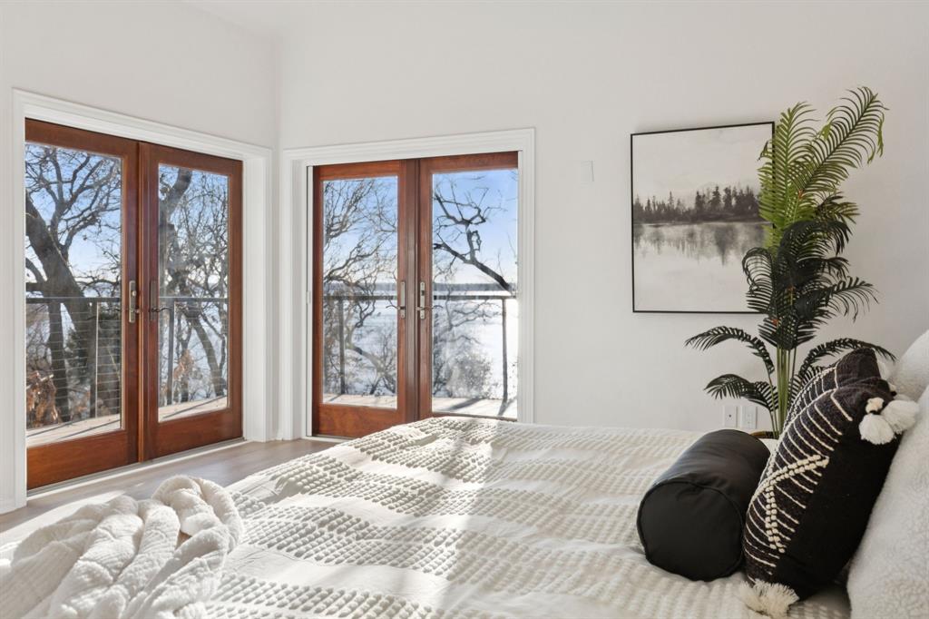 540 Diamond Point Drive Oak Point, TX 75068 - Photo 16 of 27 Bedroom with multiple windows, french doors, access to outside, and wood finished floors