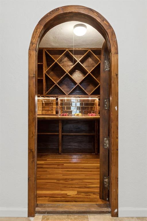 540 Diamond Point Drive Oak Point, TX 75068 - Photo 24 of 27 Wine area featuring arched walkways and a textured wall