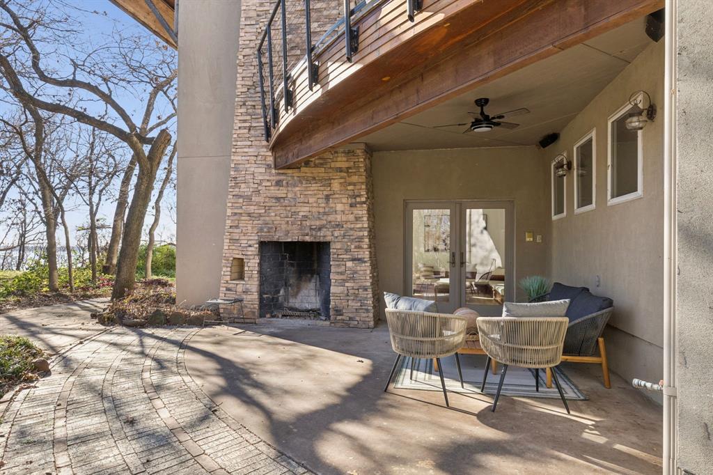 540 Diamond Point Drive Oak Point, TX 75068 - Photo 8 of 27 View of patio / terrace with an outdoor stone fireplace, french doors, and ceiling fan