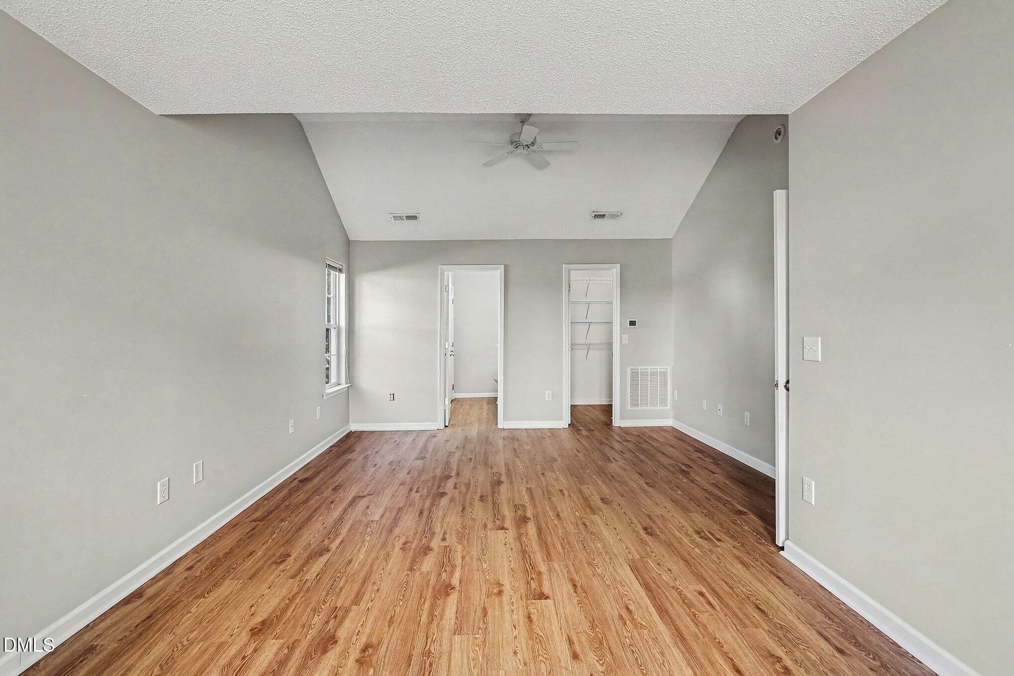 5017 Tapestry Terrace Durham, NC 27713 - Photo 14 of 28 an empty room with wooden floor and windows