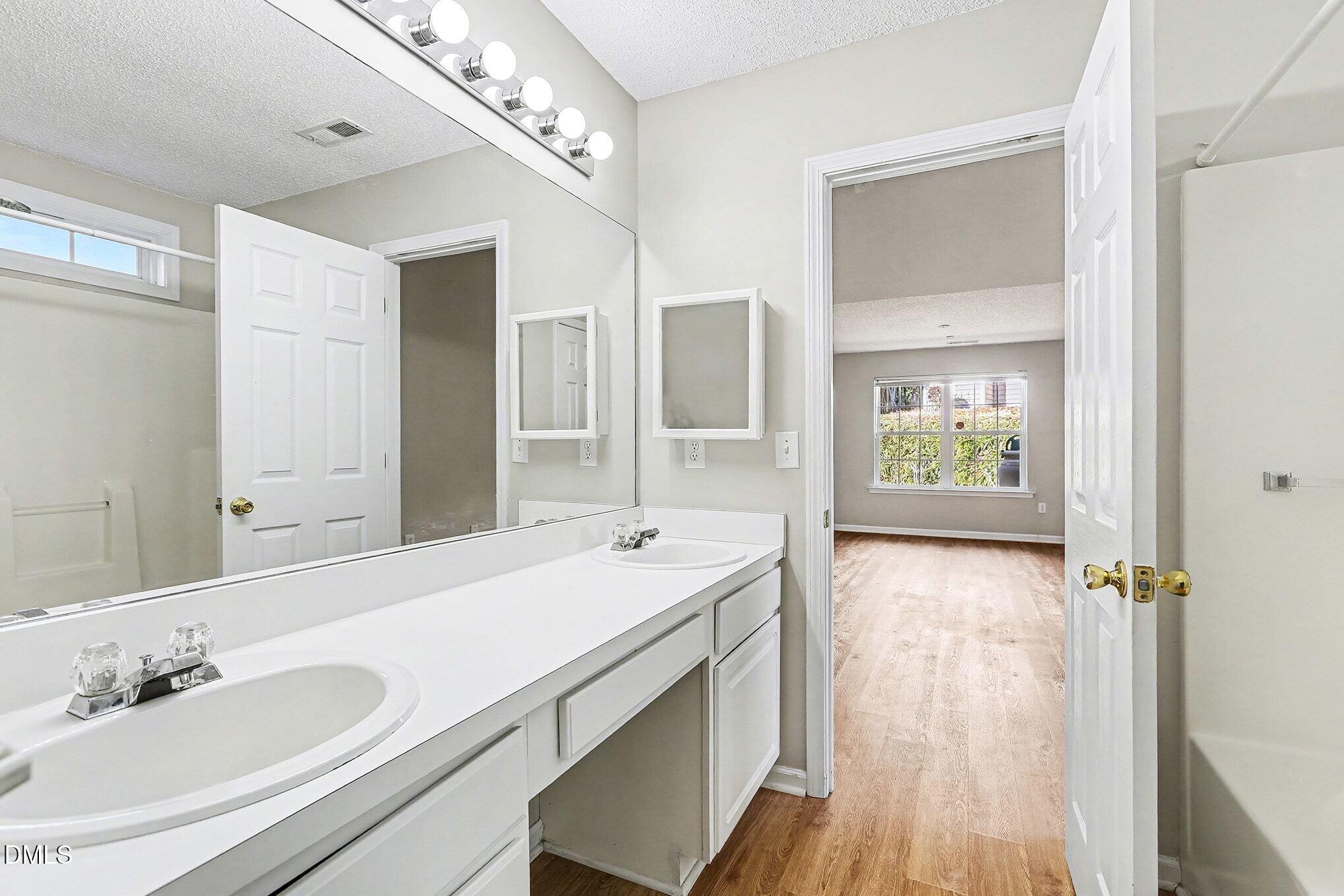 5017 Tapestry Terrace Durham, NC 27713 - Photo 15 of 28 a bathroom with a sink and a mirror
