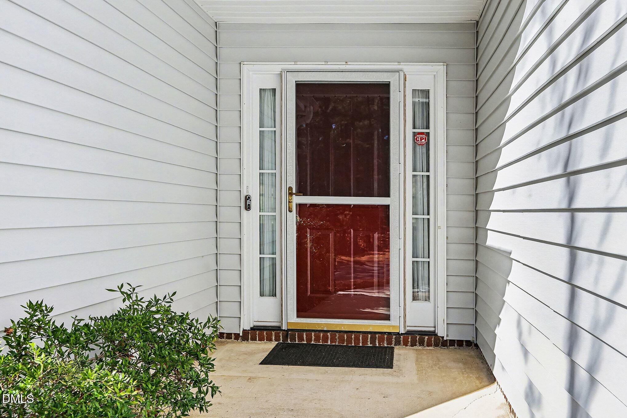 5017 Tapestry Terrace Durham, NC 27713 - Photo 2 of 28 a door and a window in an empty room