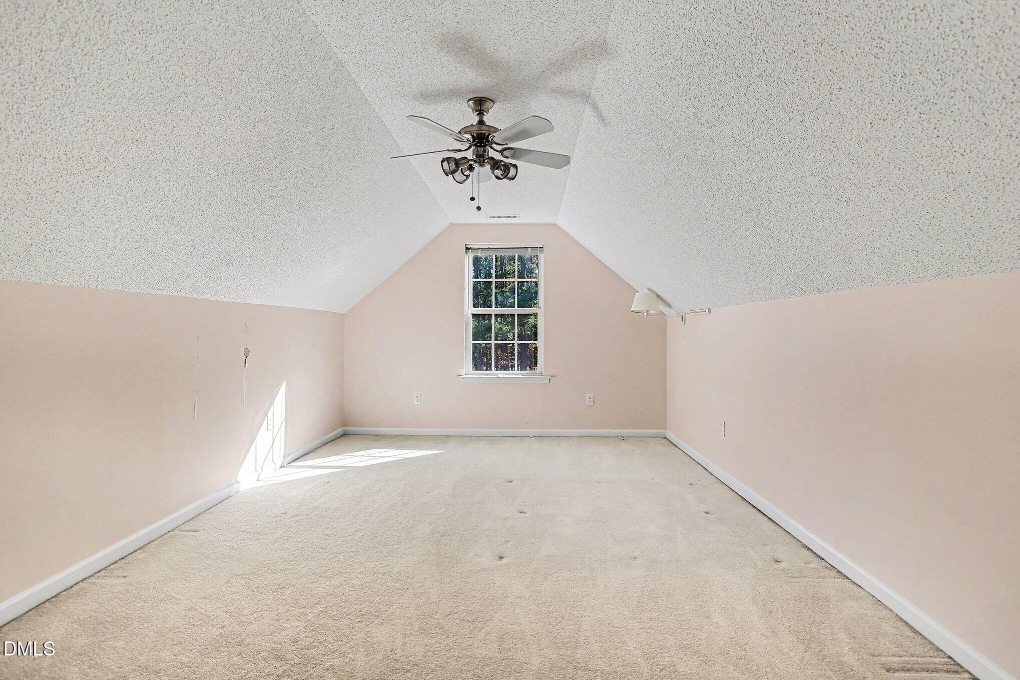 5017 Tapestry Terrace Durham, NC 27713 - Photo 21 of 28 an empty room with windows and chandelier fan