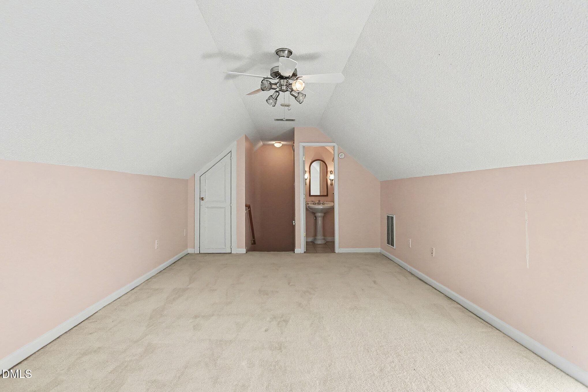 5017 Tapestry Terrace Durham, NC 27713 - Photo 22 of 28 an empty room with a chandelier fan and wooden floor
