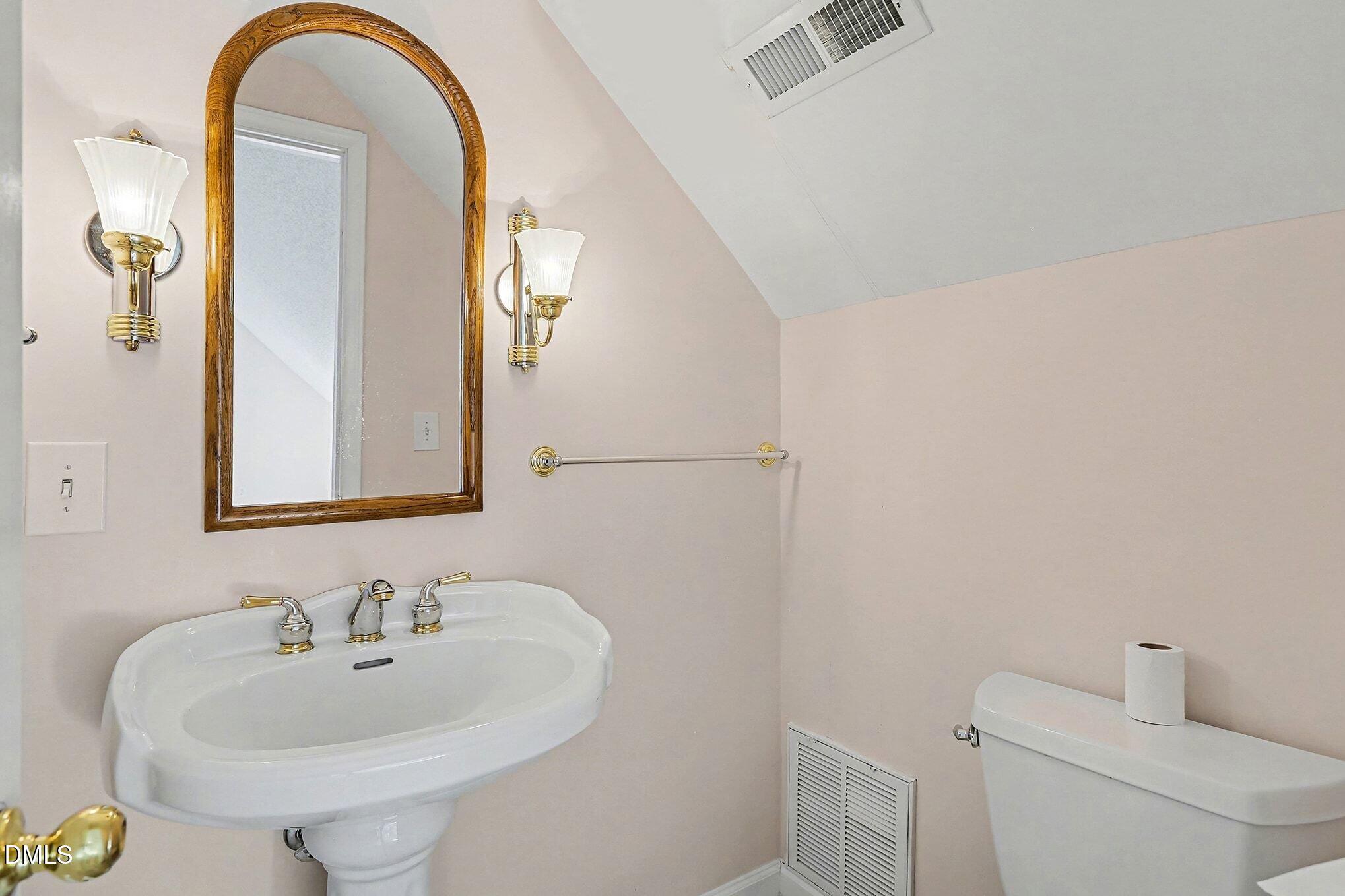 5017 Tapestry Terrace Durham, NC 27713 - Photo 23 of 28 a bathroom with a sink and a mirror