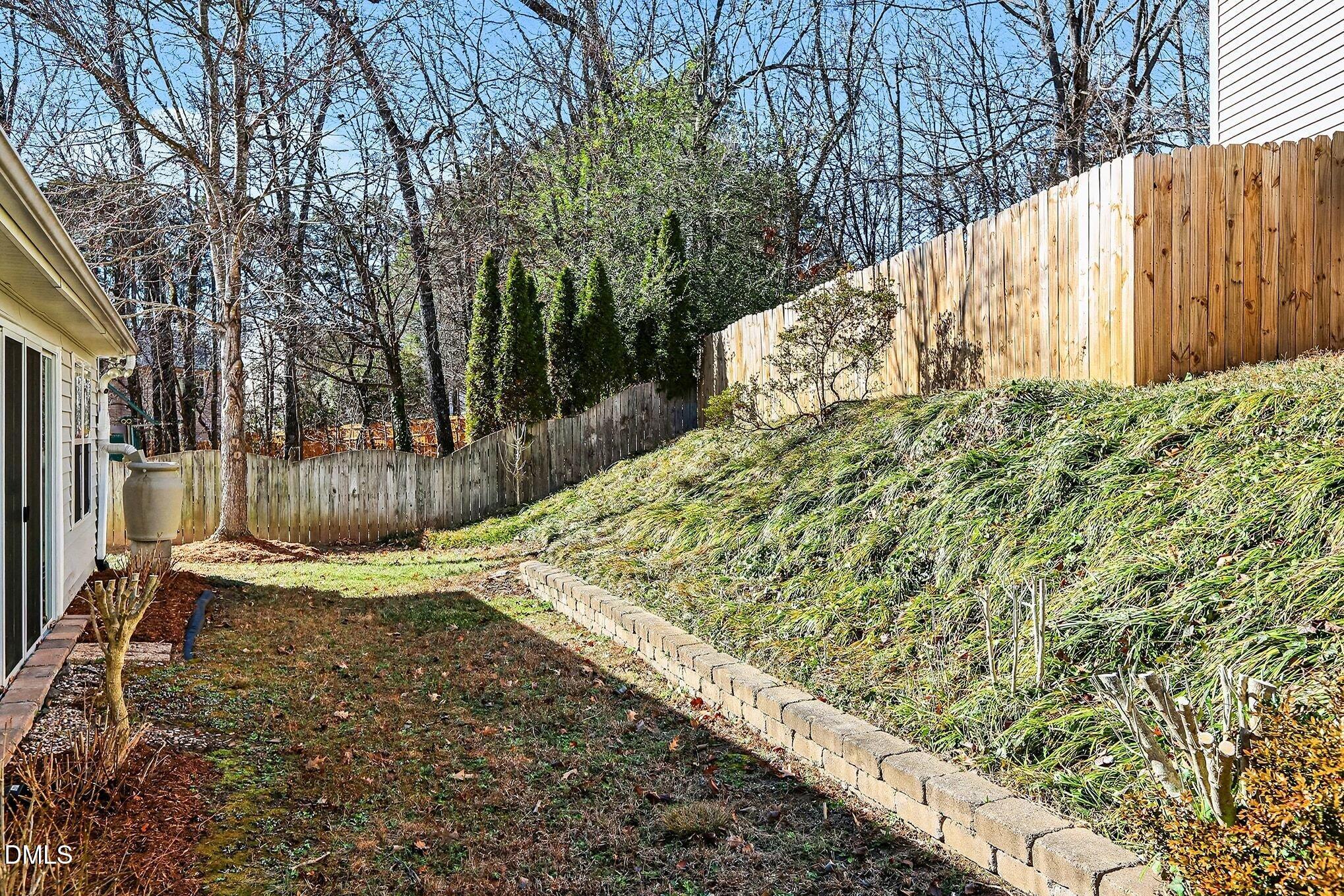 5017 Tapestry Terrace Durham, NC 27713 - Photo 27 of 28 a view of a backyard with pathway