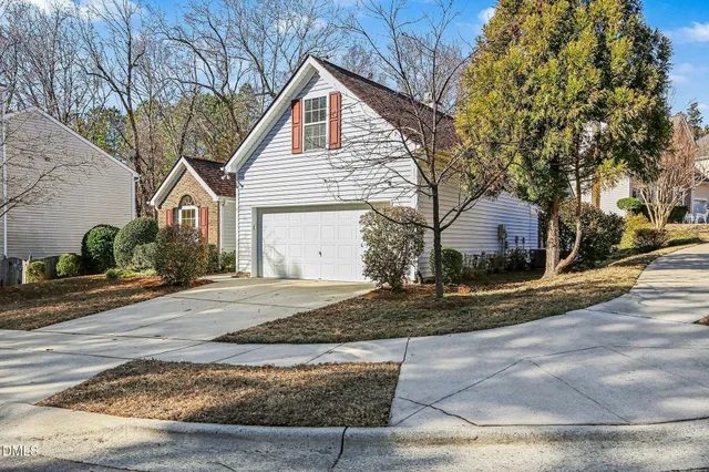 a view of a house with a yard and garage