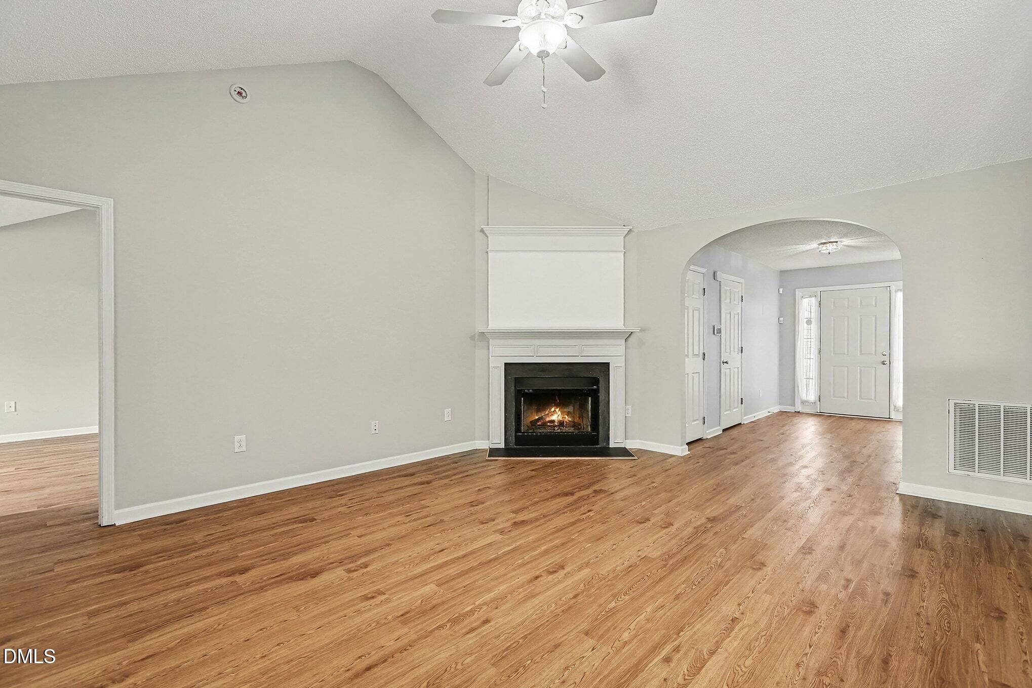 5017 Tapestry Terrace Durham, NC 27713 - Photo 6 of 28 a view of empty room with wooden floor and fireplace