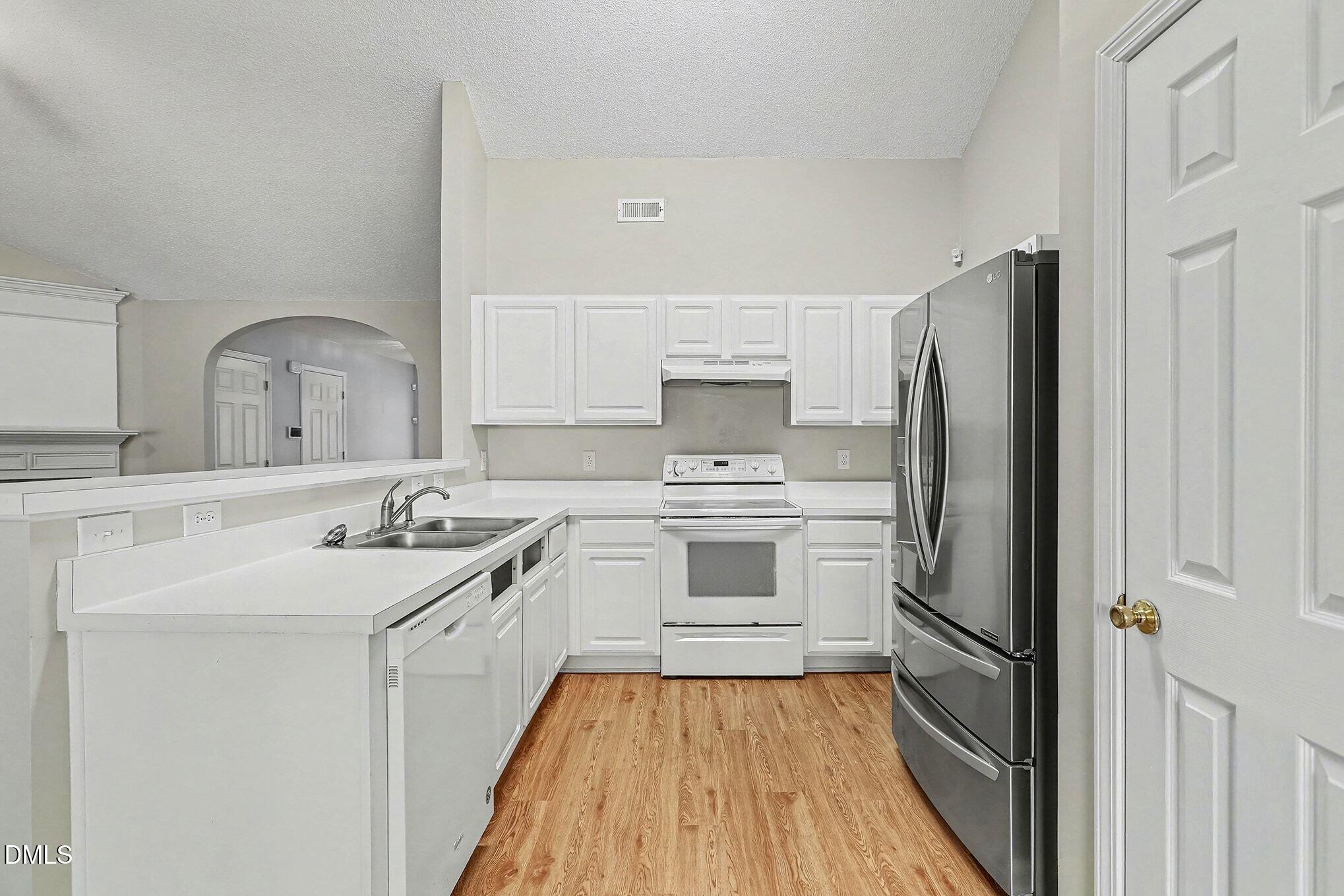 5017 Tapestry Terrace Durham, NC 27713 - Photo 8 of 28 a kitchen with a sink stove and refrigerator