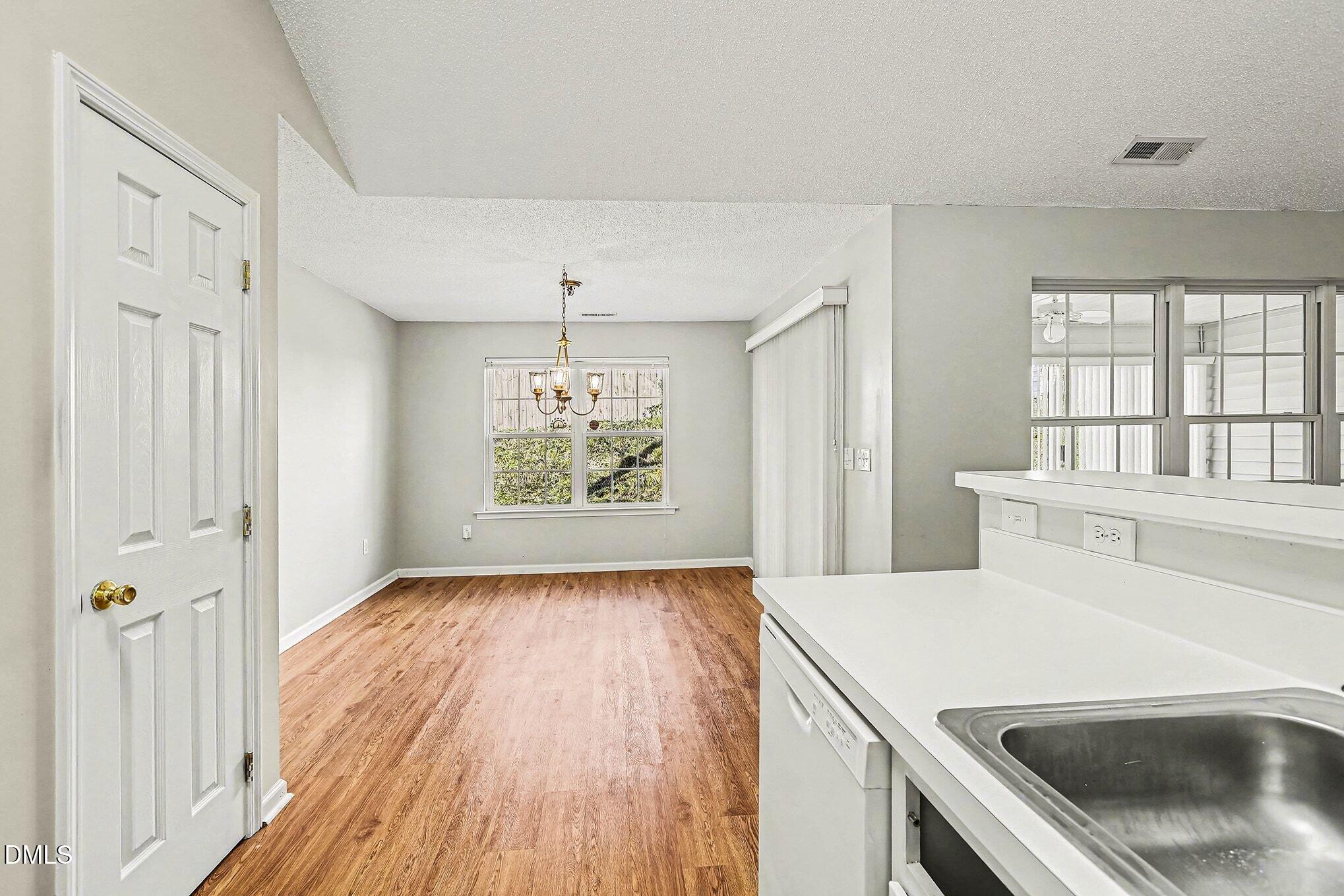 5017 Tapestry Terrace Durham, NC 27713 - Photo 9 of 28 a view of a kitchen cabinets and wooden floor