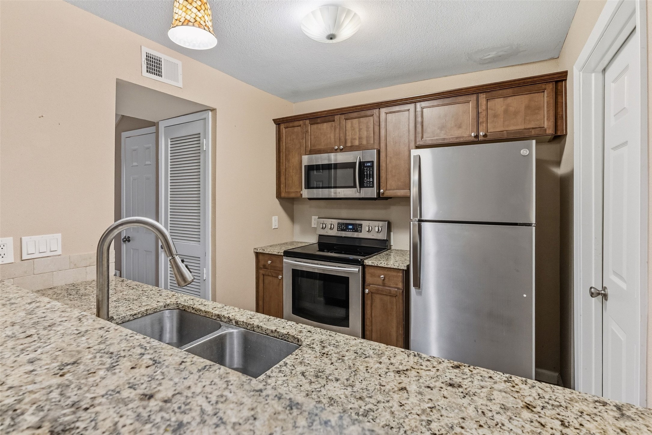 702 Castle Ridge Road, Unit C Austin, TX 78746 - Photo 32 of 36 This updated two-story residence offers approximately 1,144 square feet with 2 bedrooms, 1.5 bathrooms, and an open floor plan filled with natural light. Features include vinyl and tile flooring throughout with no carpet, granite countertops, and a walk-in shower. The main level features a comfortable living area that flows into the dining space and kitchen, creating an ideal setting for daily living and entertaining.