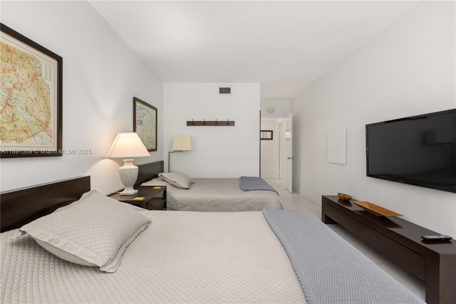 101 Crandon Boulevard, Unit 379 Key Biscayne, FL 33149 - Photo 12 of 37 a bedroom with a bed and flat screen tv