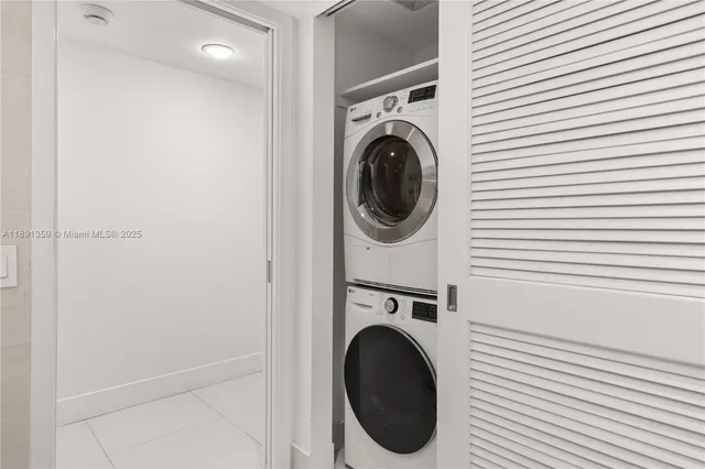 a view of a hallway with washer and dryer