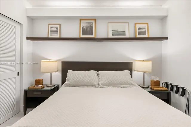 a bedroom with a bed and a night stand