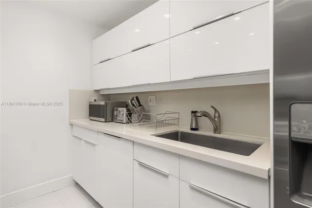 a kitchen with stainless steel appliances a sink and cabinets