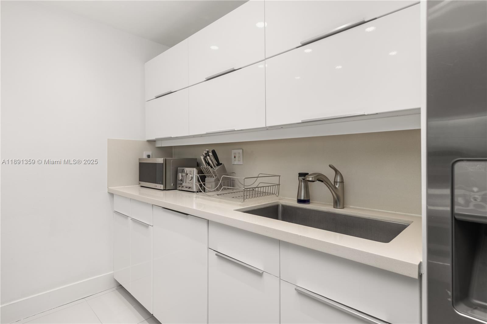 101 Crandon Boulevard, Unit 379 Key Biscayne, FL 33149 - Photo 20 of 37 a kitchen with stainless steel appliances a sink and cabinets