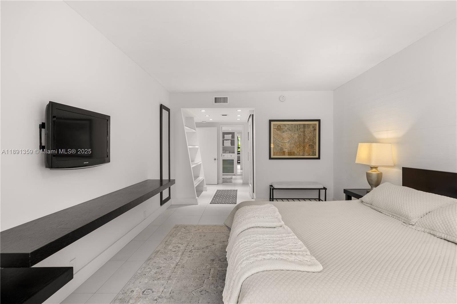 101 Crandon Boulevard, Unit 379 Key Biscayne, FL 33149 - Photo 6 of 37 a bedroom with a large bed and a flat screen tv