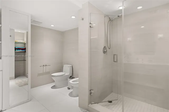 a bathroom with a toilet sink and shower