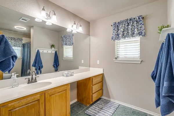 a bathroom with a double vanity sink and a mirror