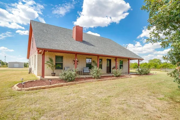 a front view of house with yard and porch