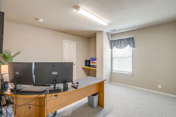 a view of work space with furniture and window