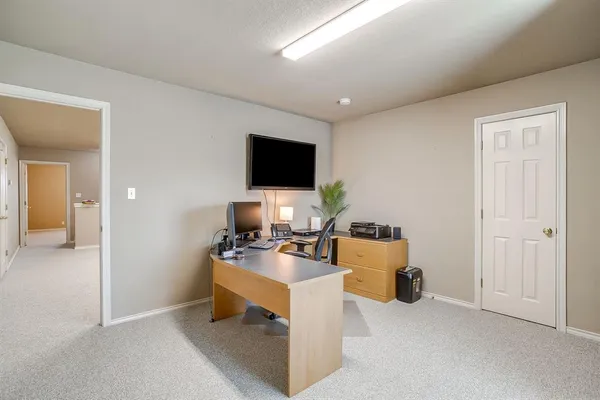a workspace with furniture and a flat screen tv