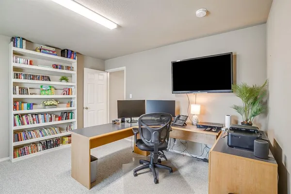 a view of a livingroom with workspace and a couch