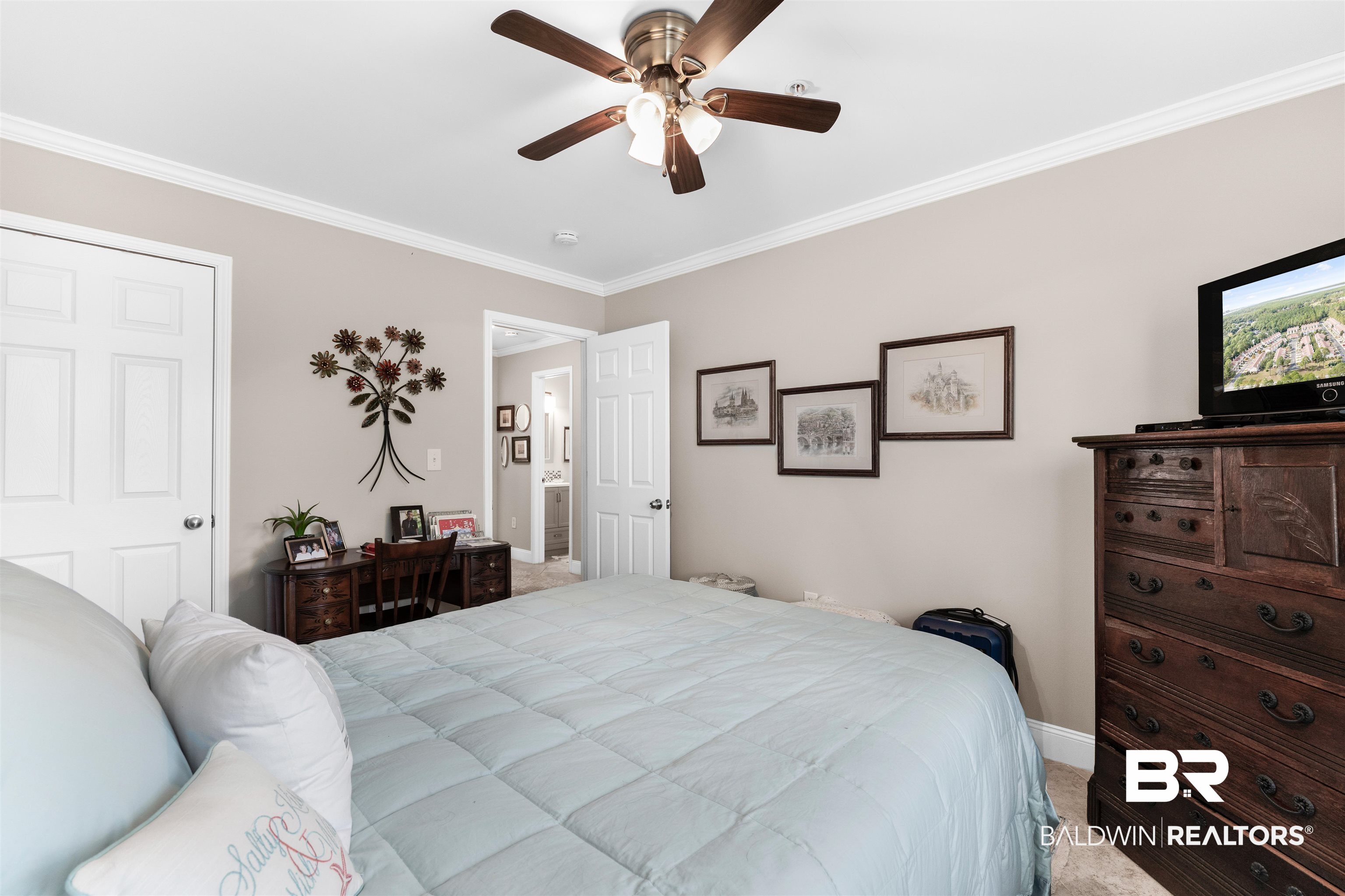1517 Regency Road, Unit 68 Gulf Shores, AL 36542 - Photo 23 of 43 Bedroom with light carpet, ceiling fan, and ornamental molding