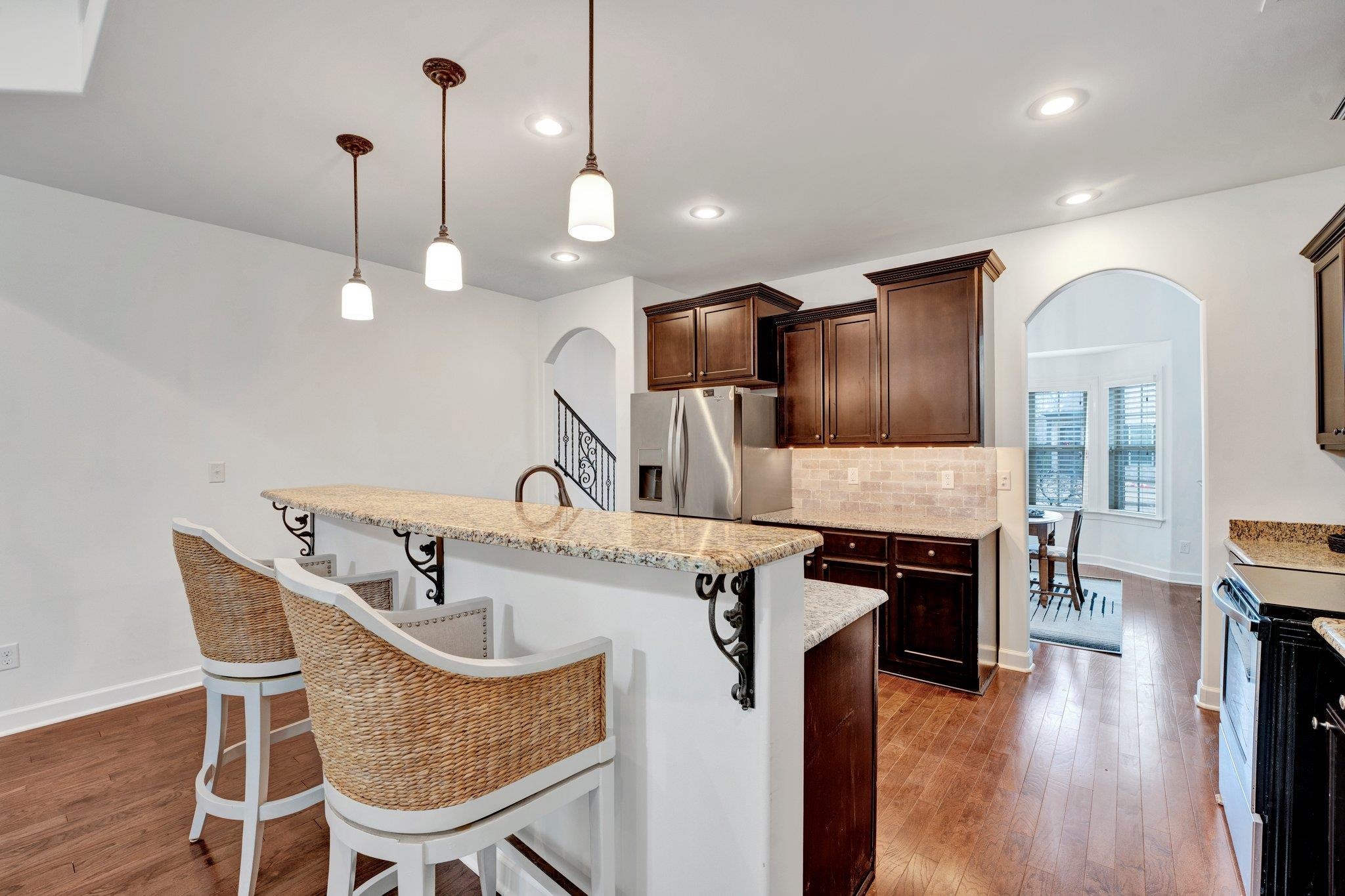 1965 Rochelle Lane Cordova, TN 38016 - Photo 11 of 40 a kitchen with stainless steel appliances granite countertop a sink a stove and a wooden floor