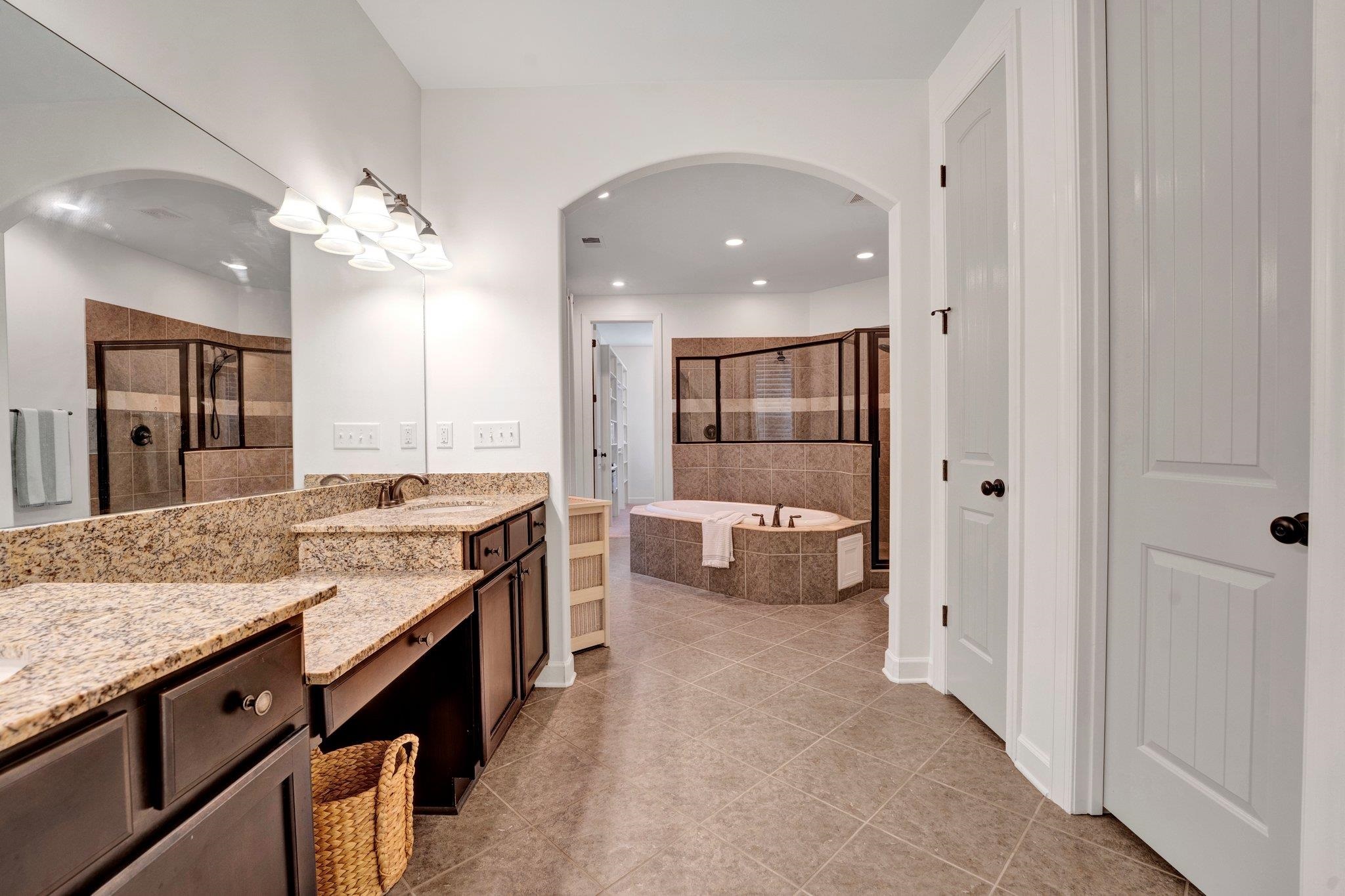 1965 Rochelle Lane Cordova, TN 38016 - Photo 26 of 40 a bathroom with a granite countertop sink a toilet a mirror and shower