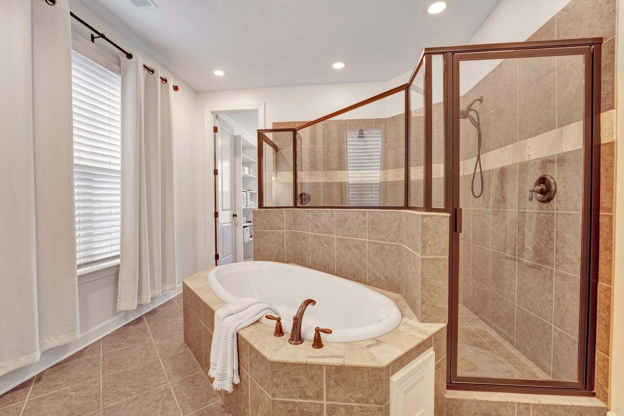 1965 Rochelle Lane Cordova, TN 38016 - Photo 29 of 40 a bathroom with a tub and a shower