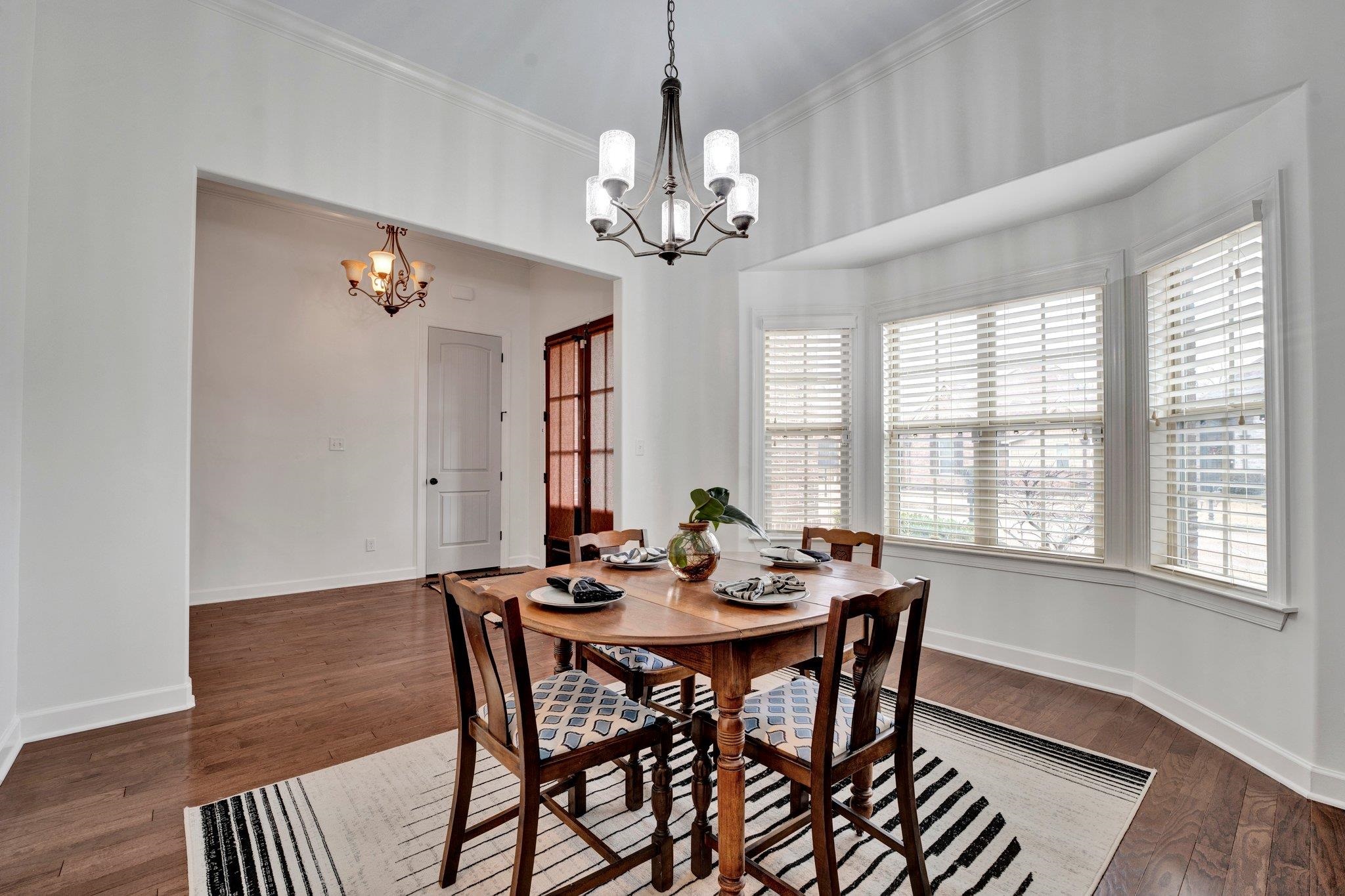 1965 Rochelle Lane Cordova, TN 38016 - Photo 3 of 40 a view of a dining room with furniture a chandelier and wooden floor